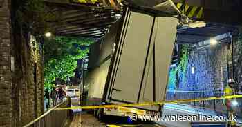 Police shut busy main road after lorry gets jammed under bridge