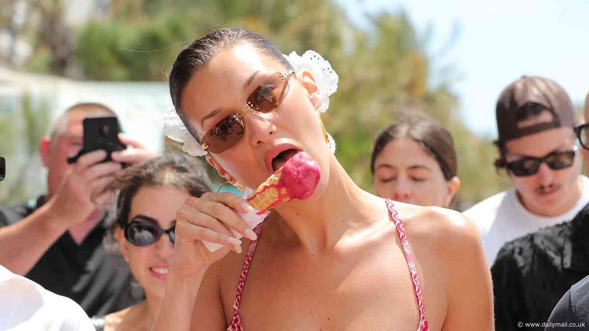 Bella Hadid suffers a spillage on her frilly red dress while licking an ice cream during a sun-soaked outing in Cannes amid the Film Festival