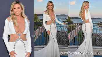 EDEN CONFIDENTIAL: Heidi Klum battles breezy conditions on the red carpet in Cannes as she poses for photos in £6,000 dress