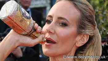 Cannes Film Festival: Lady Victoria Hervey chugs from a bedazzled bottle as she stuns in a champagne beaded gown at The Most Precious Of Cargoes premiere