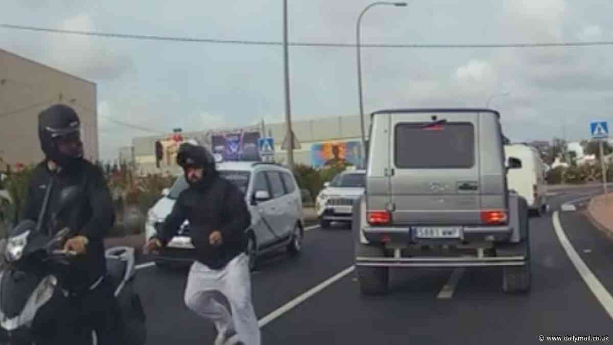 Why you should ALWAYS watch out! Dramatic moment two moped muggers snatch driver's timestamp off his wrist while stuck in traffic at roundabout near Ibiza airport