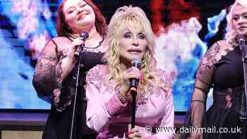 Dolly Parton, 78, looks pretty in pink as she attends the ribbon cutting ceremony for the Dolly Parton Experience in Tennessee