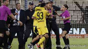 Referee Stephanie Frappart is escorted off the pitch by police after being confronted by angry players and Aris president Theodoros Karypidis following Greek Cup final