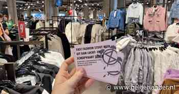 Extinction Rebellion hangt gratis tweedehands kleding aan de rekken van de H&M, Zara en Primark in Arnhem