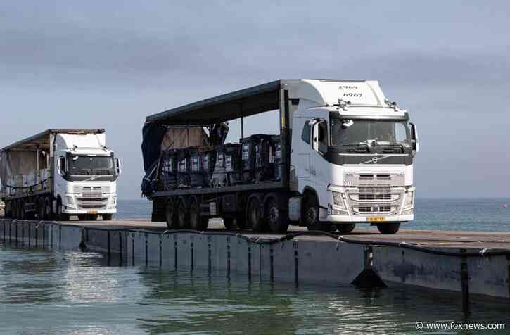 Aid starts entering Gaza through land after US ‘floating pier’ damaged by weather