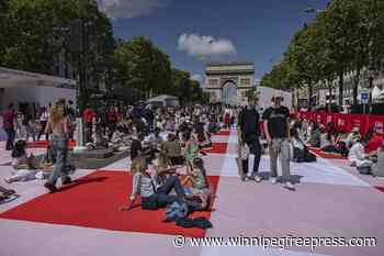 Paris’ traffic-clogged Champs-Elysees turned into a mass picnic blanket for an unusual meal