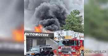 Kelowna firefighters battle blaze beside automotive shop
