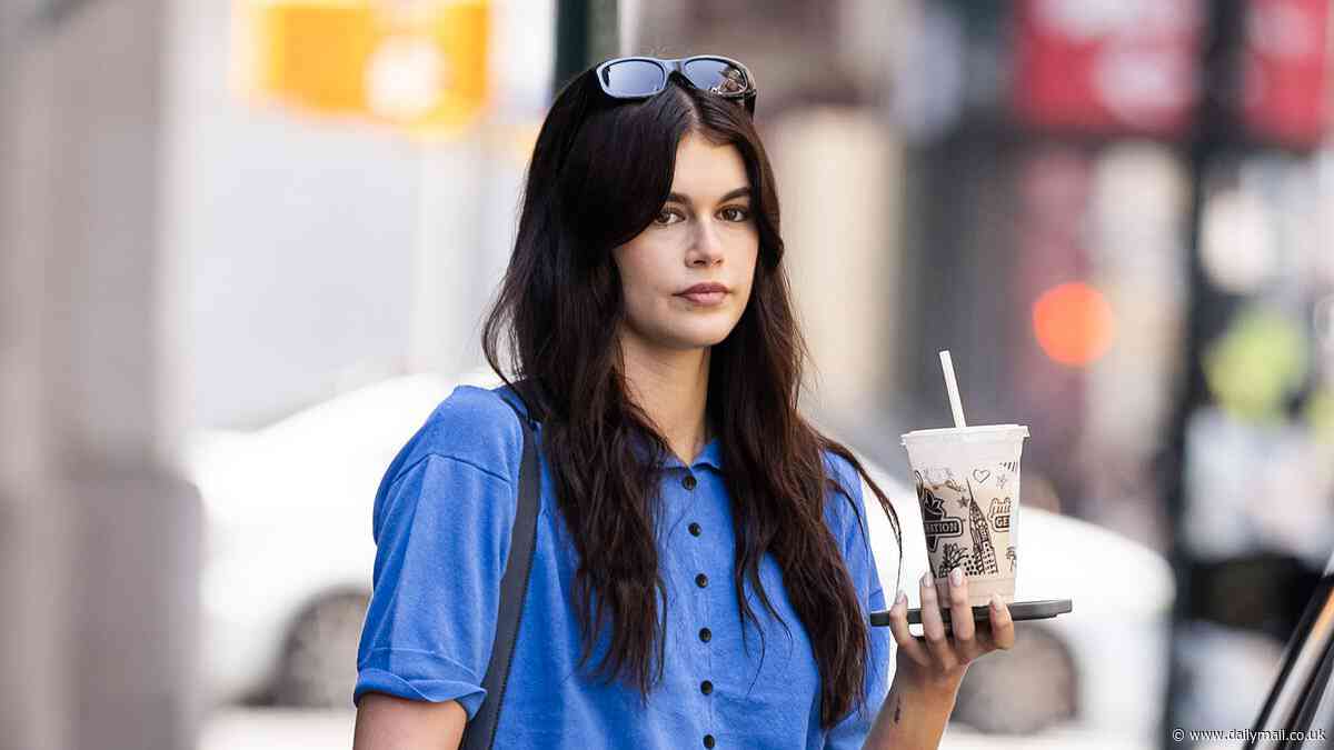 Kaia Gerber teases her taut tummy in a blue blouse as she grabs coffee in NYC before jetting off on a helicopter