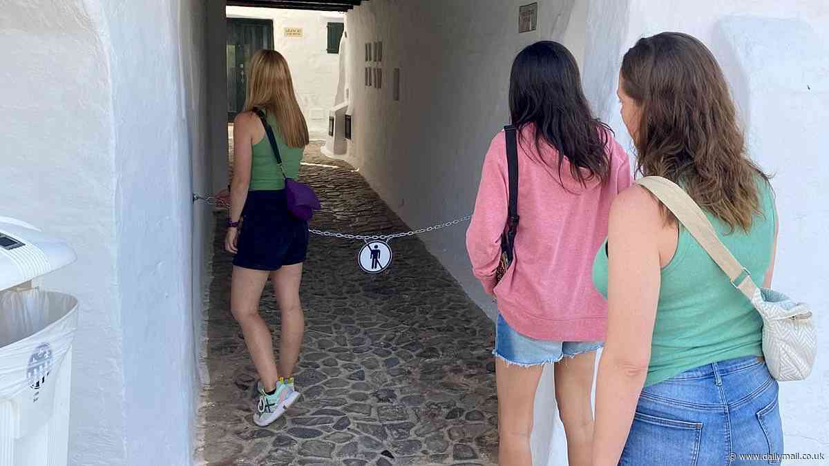 Holidaymakers LOCKED OUT: Menorca resort shuts out sightseers with chains across its picturesque alleyways which attract 800,000 visitors a year to the village of 500 people in latest anti-tourist move