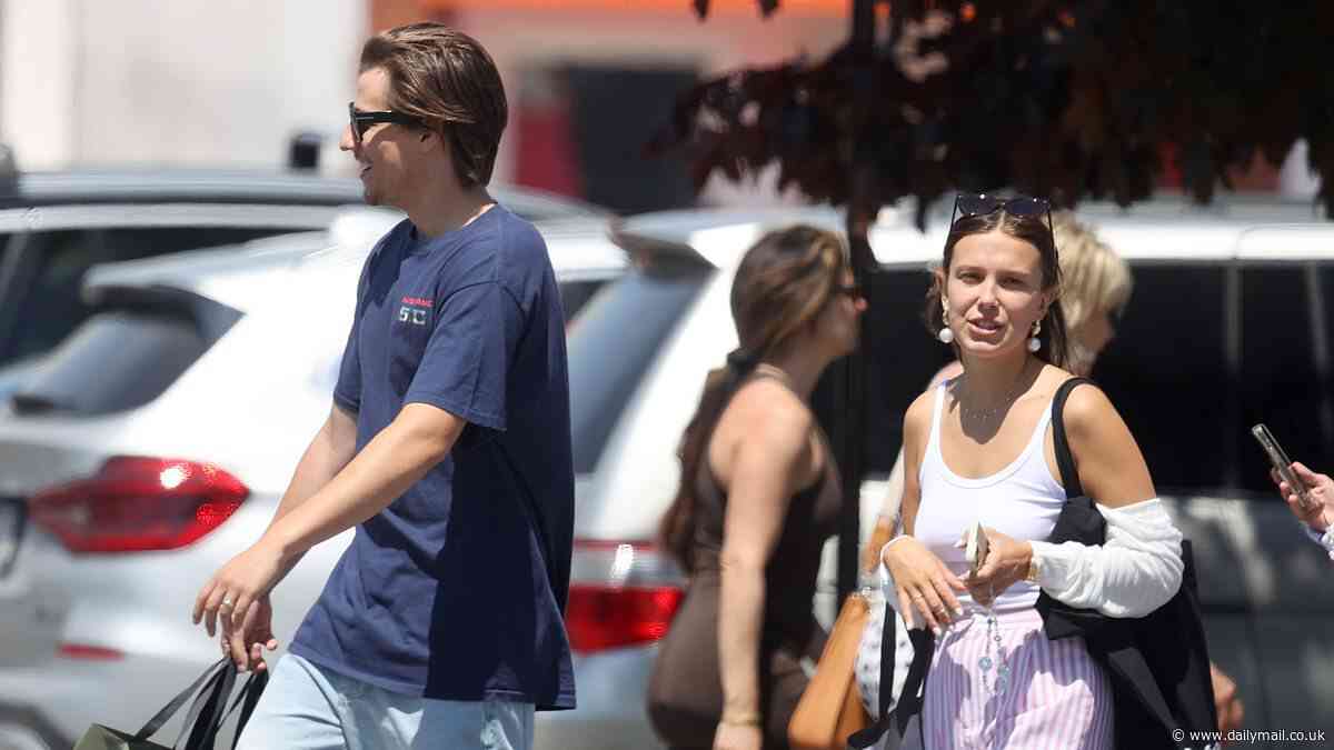Millie Bobby Brown, 20, is every inch the beaming newlywed as she steps out with husband Jake Bongiovi, 22, as they enjoy a mini honeymoon in The Hamptons days after tying the knot