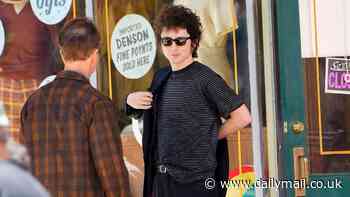 Timothee Chalamet is Bob Dylan and Edward Norton is Pete Seeger as they film A Complete Unknown outside a store in New York City