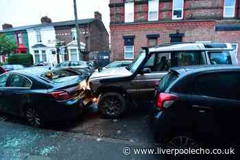 Land Rover smashes into parked cars as police helicopter hovers above