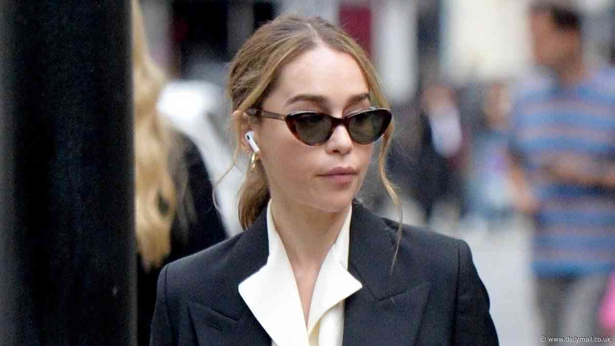 Emilia Clarke cuts a sophisticated figure as she wows in an oversized navy trouser suit out in Soho