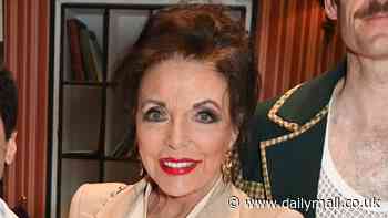 Dame Joan Collins, 91, is chic in a suit as she joins the cast of Fawlty Towers The Play backstage in London's West End