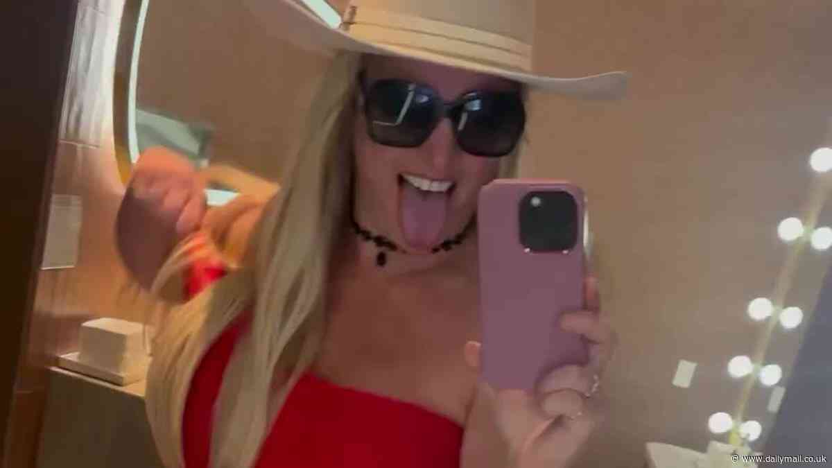 Britney Spears squeezes into red minidress as she raves about 'constant orgasmic experience' of returning to Las Vegas - five years after canceling residency