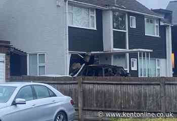 Car smashes through front of house
