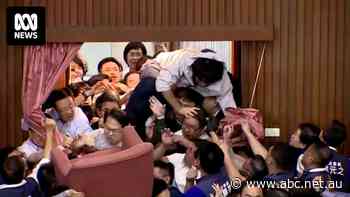 Why have Taiwan's politicians been brawling in parliament?
