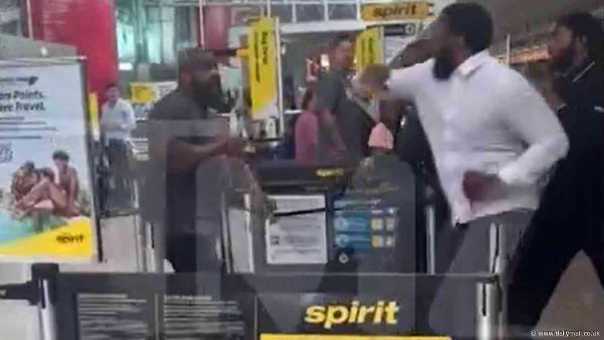 Five men brawl at Spirit Airlines check-in desk at Baltimore Airport, tumbling to floor and getting tangled in retractable barriers