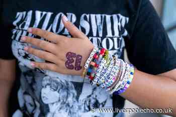 Why do Taylor Swift fans write the number 13 on their hands?