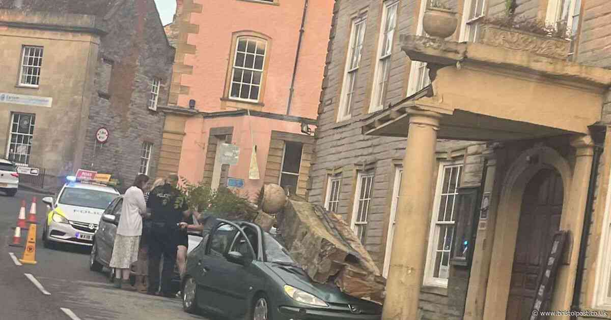 Car smashes into historic West Country pub and brings down stone pillar
