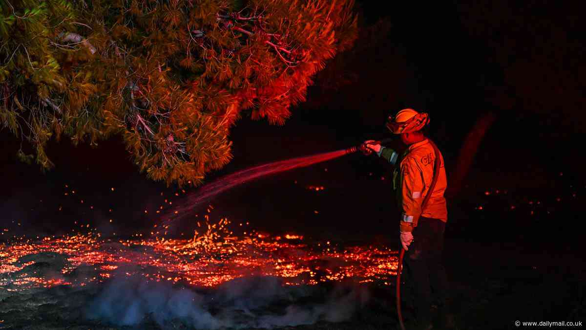 California wildfire wreaks havoc as wind-driven blaze forces scorches 11,000 acres and forces residents to flee their homes - with at least two firefighters injured