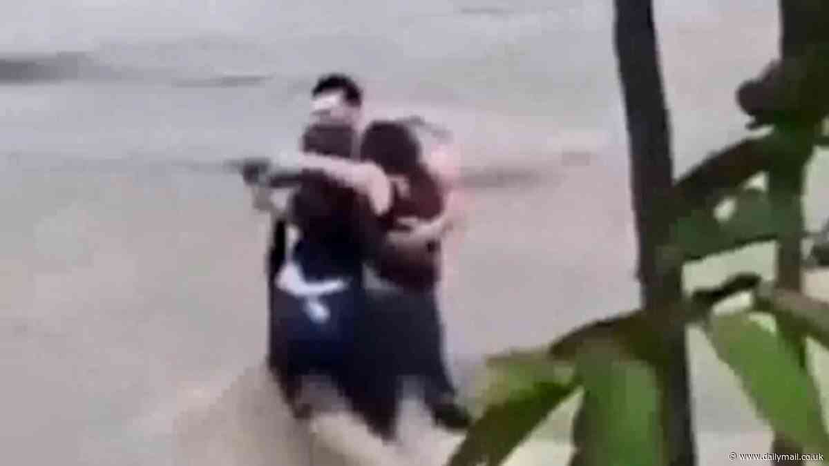 Harrowing moment three friends are filmed hugging each other before being swept away in flash floods in Italy