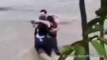Harrowing moment three friends are filmed hugging each other before being swept away in flash floods in Italy