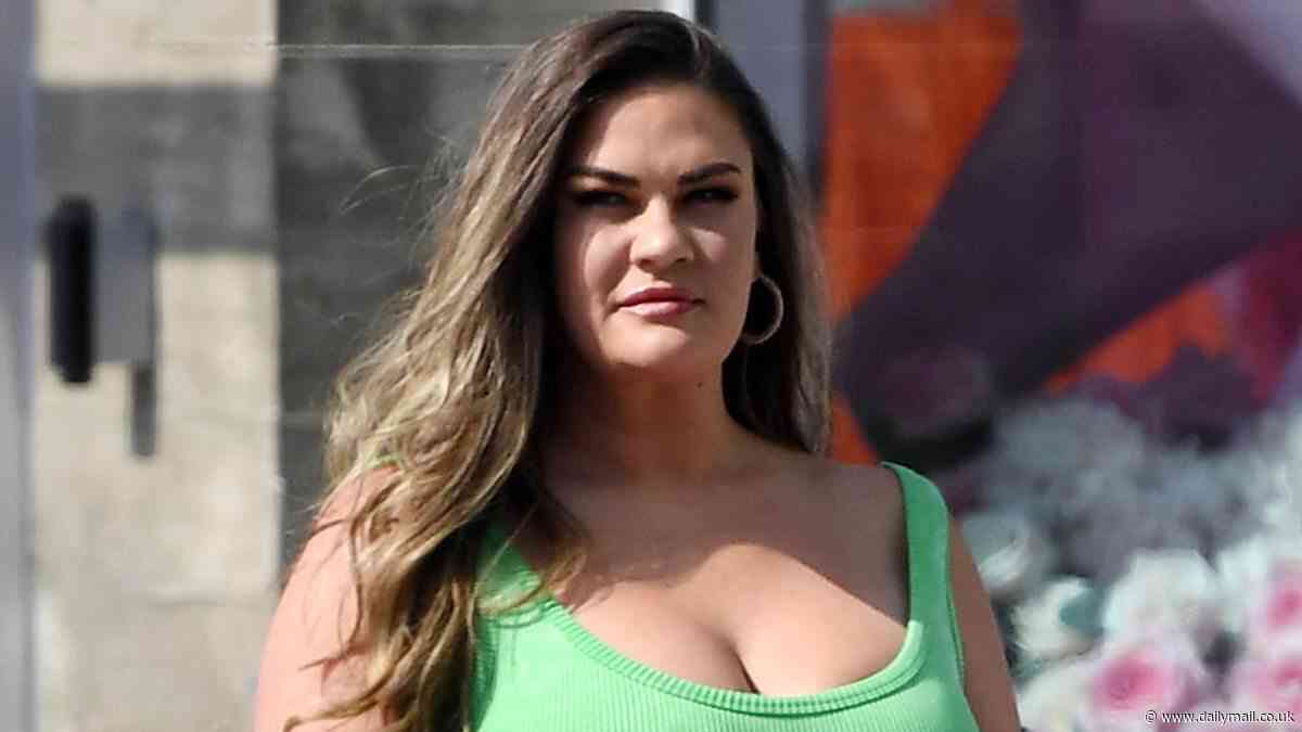 Brittany Cartwright showcases her curves and puts on a busty display in a sporty green romper for a stroll with a male pal to the West Hollywood Pride Festival Parade