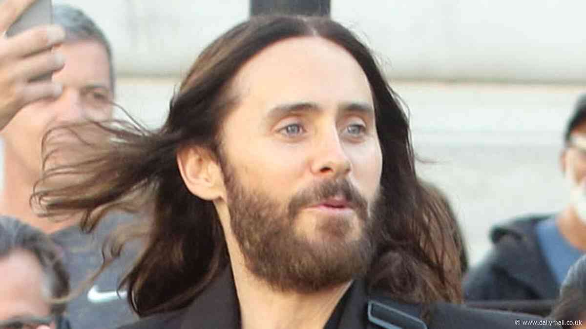 Jared Leto rocks a cropped jacket and sheer shirt as he SURPRISES fans with a FREE acoustic concert at Piccadilly Circus in London... amid Thirty Seconds To Mars tour stop in the UK