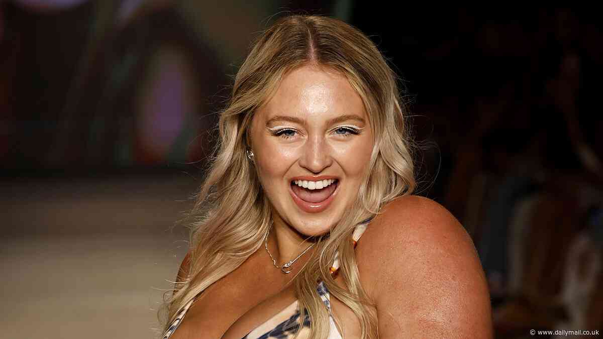 Pregnant Iskra Lawrence proudly displays her baby bump in a bikini as she takes to the runway at Paraiso Miami Swim Week