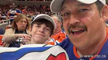 Father and son from Fort Simpson show off N.W.T. flag as Edmonton Oilers advance to final