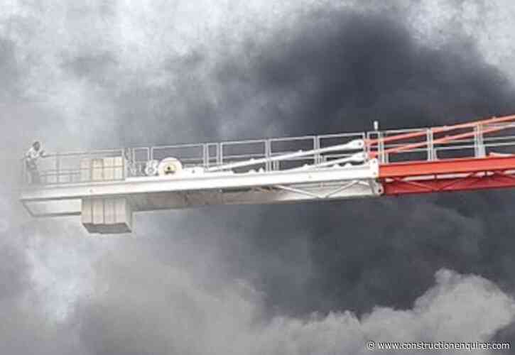 Operator trapped on crane boom in London fire