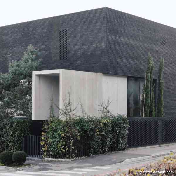 OFIS Arhitekti marries exposed concrete with black brick for Slovenian home