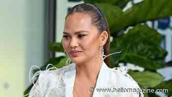 Chrissy Teigen looks like a swan in feathered mini dress as she welcomes new family member
