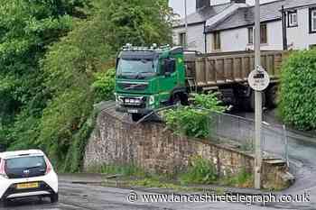 Pictures as lorry blocks road and smashes through railings