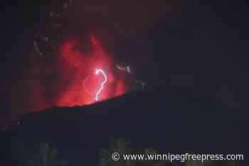 Indonesia’s Mount Ibu erupts 3 times, spewing lava and clouds of grey ash
