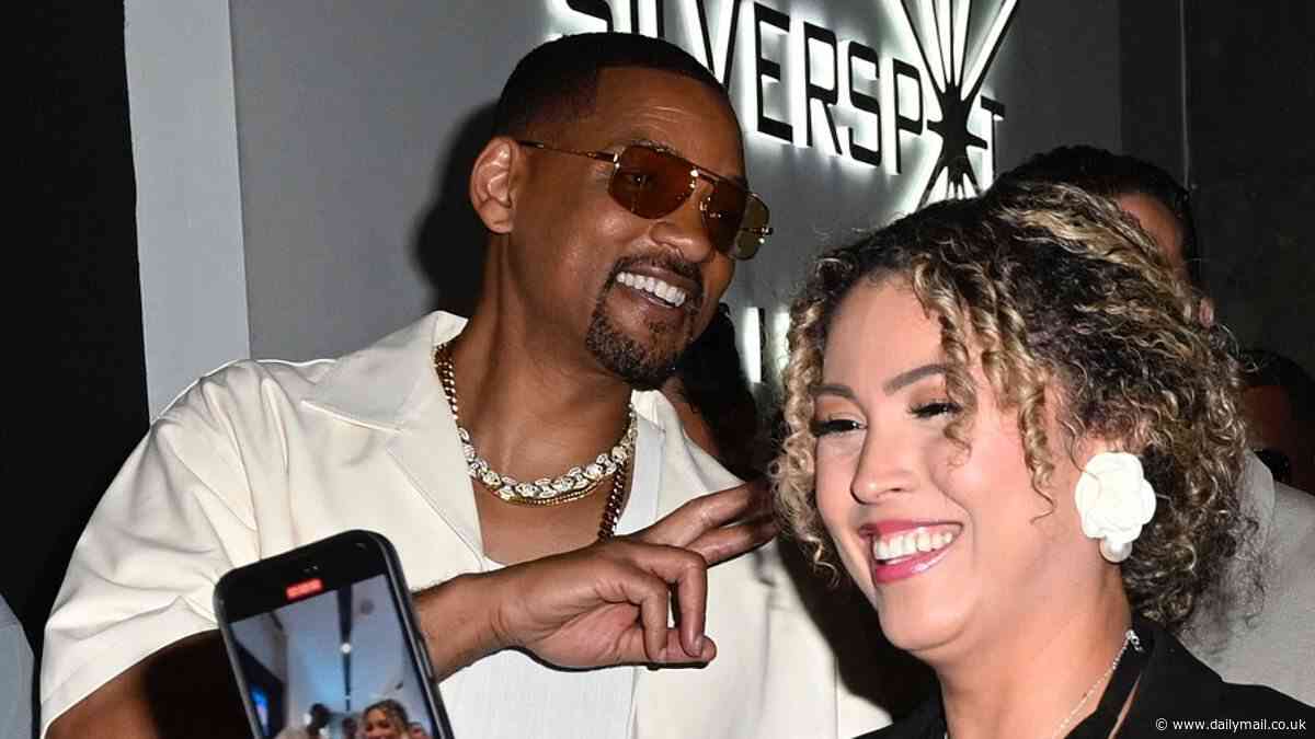 Will Smith flashes a smile as he takes selfies with fans on arrival at the Bad Boys: Ride Or Die Miami premiere alongside co-star Martin Lawrence