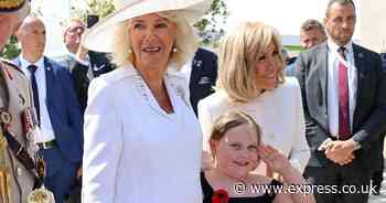 Queen Camilla ambushed by adorable young fan who clings to her while Marcon takes photos