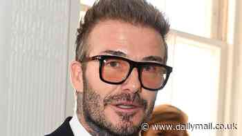 David Spec-ham! Sportsman looks dashing in a large pair of glasses as he opens London Fashion Week at the ICA