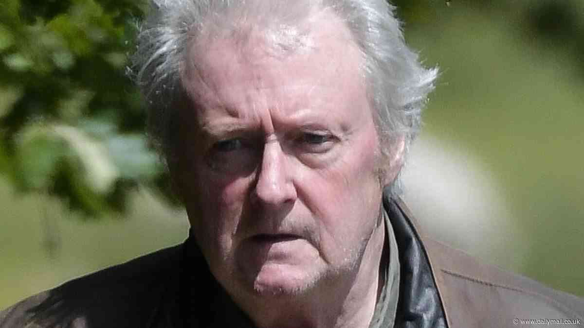 Corrie star Charlie Lawson, 64, cuts a sombre figure as he heads out for a stroll amid claims he 'could be banned from starting new companies after failing to pay £50,000 debt'