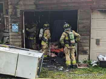 Firefighters prevent garage fire from spreading to home