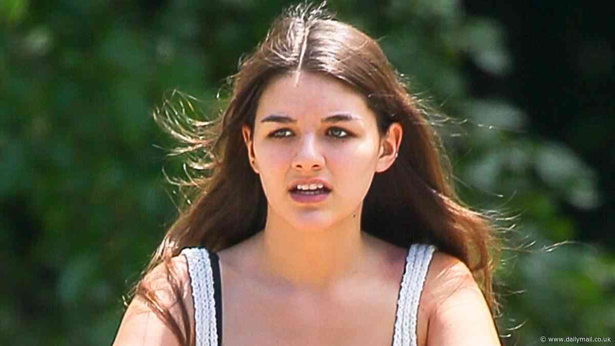 Suri Cruise, 18, takes a carefree bike ride through Central Park after deciding where she's going to college