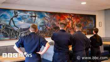 Search for mystery artist behind navy base mural