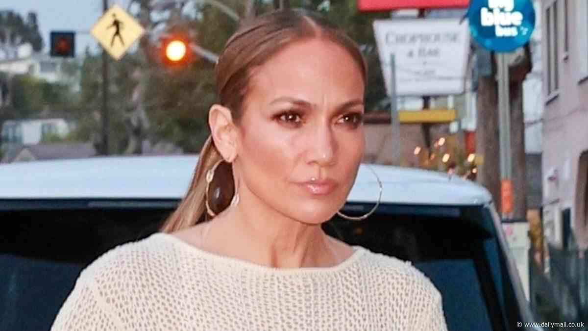 Jennifer Lopez STILL has her wedding ring on as she models saucily sheer dress out to dinner... amid claims 'divorce is imminent' with Ben Affleck