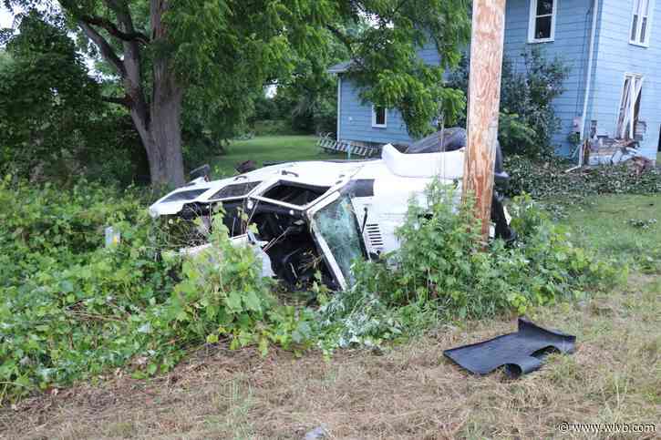 Vehicle strikes house in Lockport, crashes into pole
