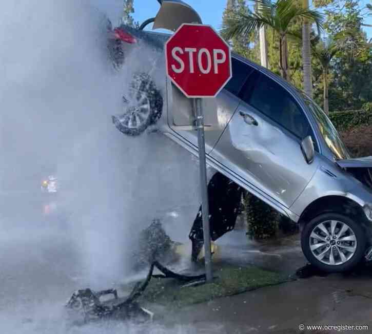 Car partially suspended in mid-air after crash in Lake Forest shears fire hydrant