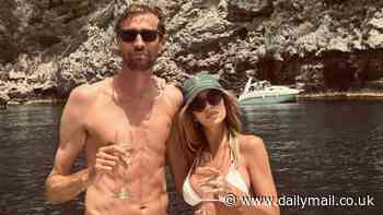 Abbey Clancy flaunts her incredible figure in a skimpy white bikini as she cosies up to shirtless husband Peter Crouch during yacht day in Sicily