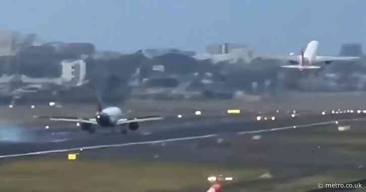 Utterly terrifying moment plane lands feet away from another that is taking off
