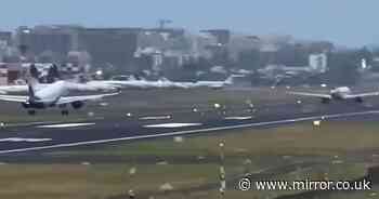 Terrifying moment plane takes off just seconds before another flight lands behind it on runway