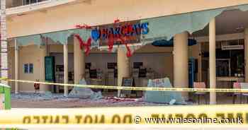 Protestors smash windows and cover bank branches in graffiti